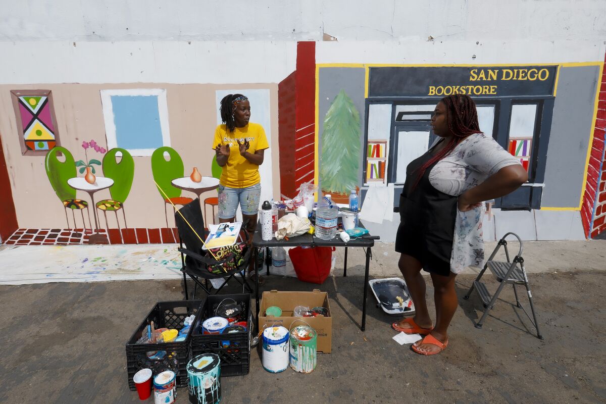 Kim Phillips-Pea and Raquel Rhone painted murals in Lincoln Park neighborhood