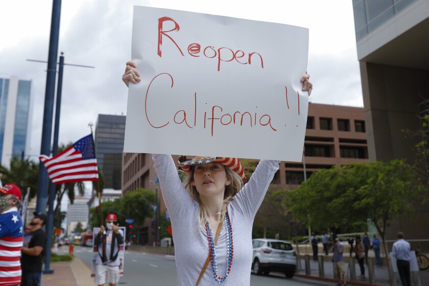 Angela Royal was among the estimated 200 supporters calling to reopen California. The group held their rally on the corner at State Street and Broadway in San Diego on Saturday.