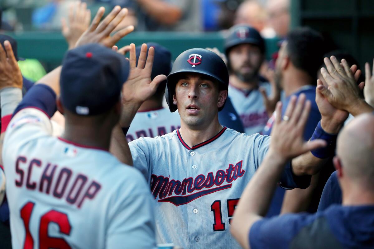 Minnesota Twins catcher Jason Castro celebrates with teammates after scoring a run against the Texas Rangers in August.