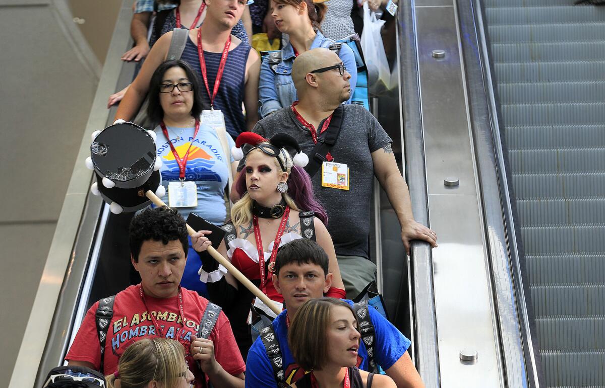 Fans take an escalator to the convention floor at Comic-Con International July 24, 2014 in San Diego.