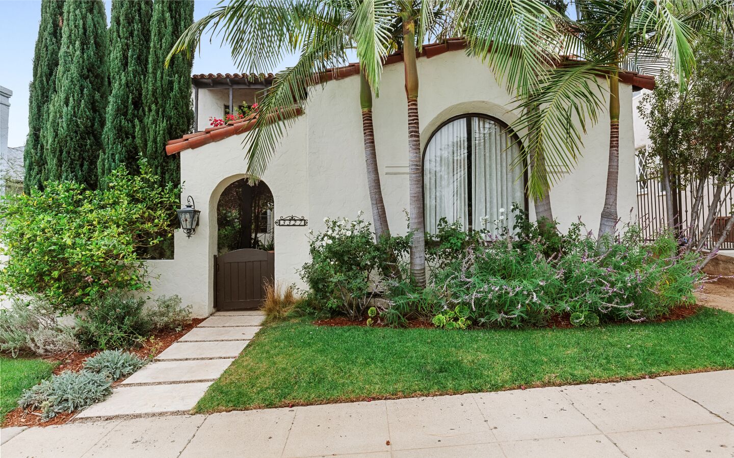 Built in 1932, the designer-done home includes a stylish backyard with a swimming pool and cabana surrounded by vegetable gardens and fruit trees.