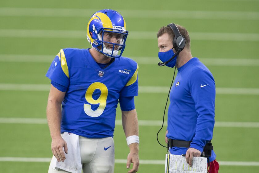 Los Angeles Rams quarterback John Wolford (9), left, talks to head coach Sean McVay.