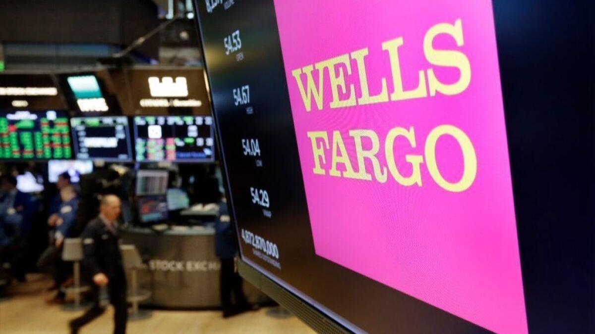 The logo for Wells Fargo appears above a trading post on the floor of the New York Stock Exchange in May.