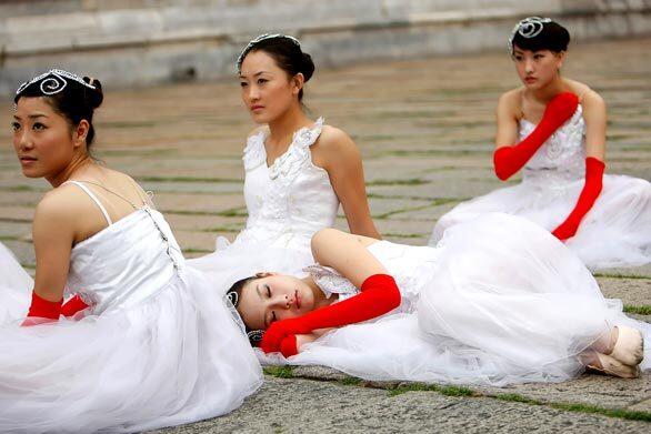 Young performers wait backstage at a Tiananmen Square reception for the Olympic torch relay.