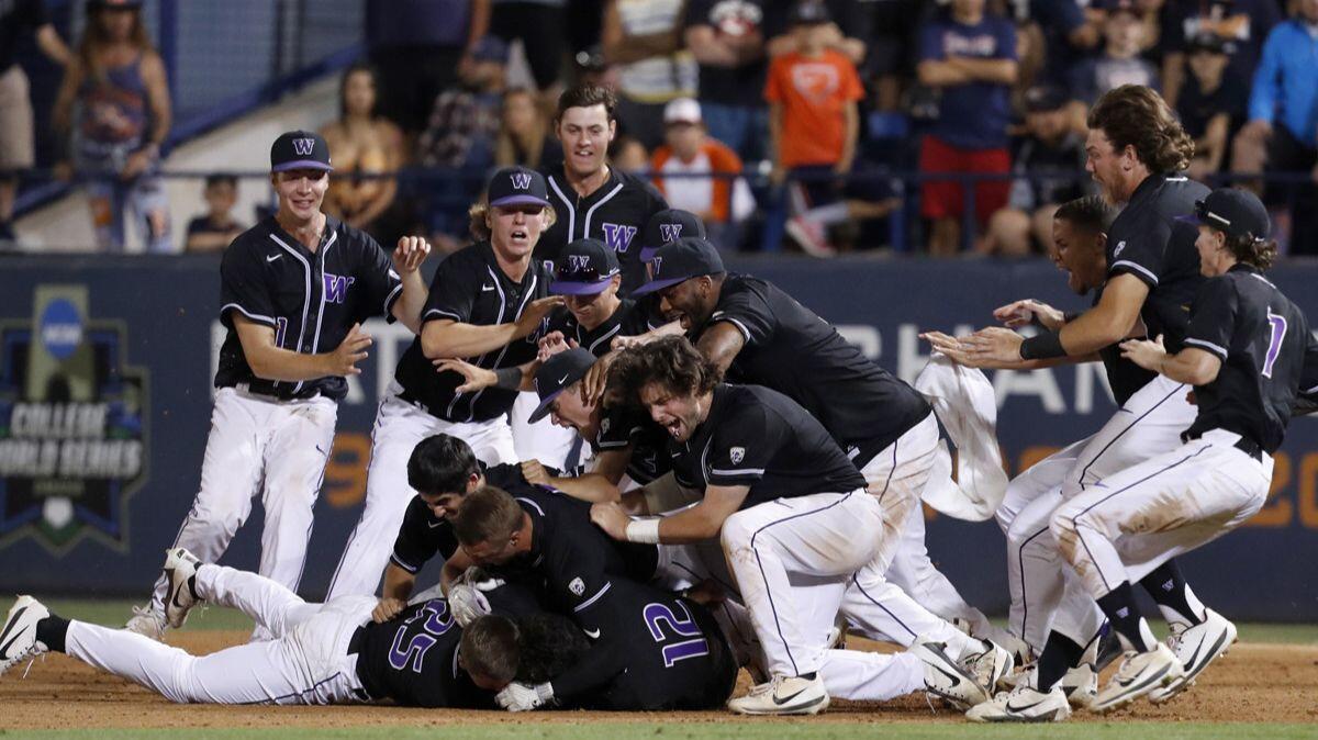 Washington players celebrate after beating the Cal State Fullerton in the 10th inning of an NCAA super regional game on Sunday.