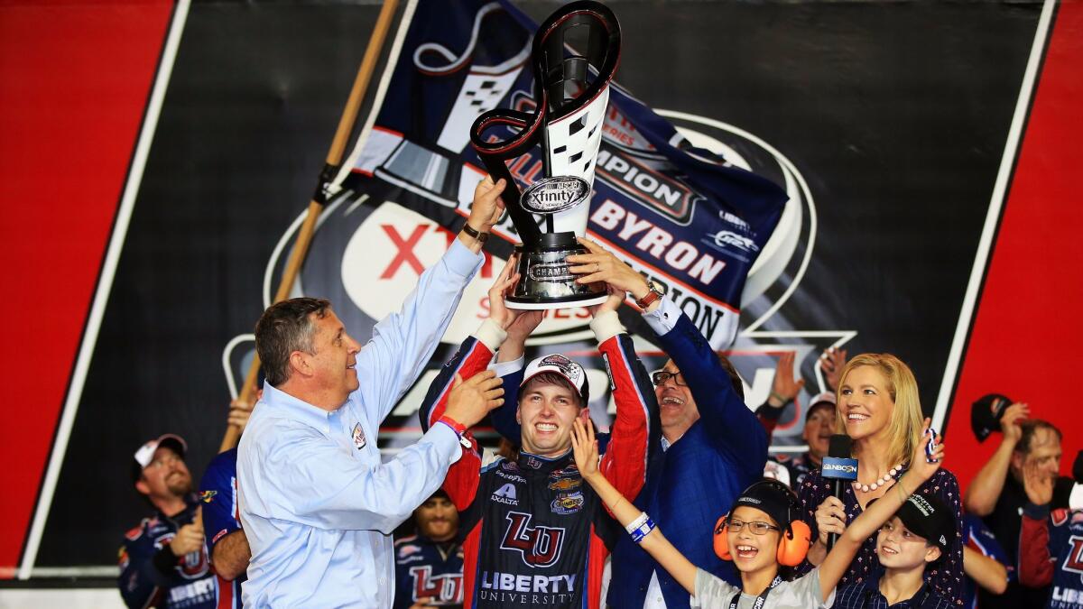 William Byron, driver of the #9 Liberty University Chevrolet, celebrates with the trophy in Victory Lane after placing third and winning the NASCAR XFINITY Series championship.