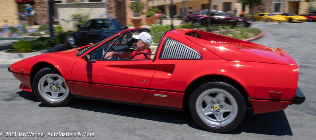 : Smiling owner driving away from the event