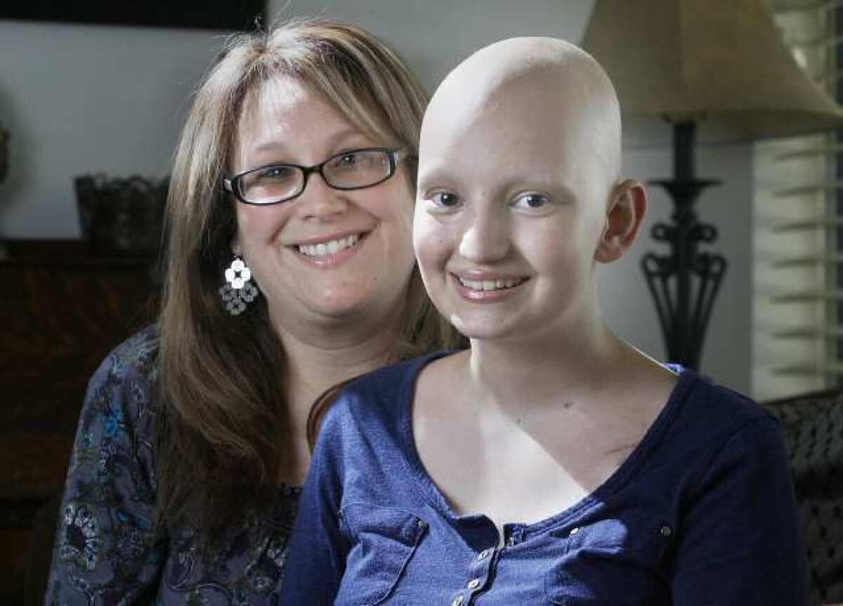 Lisa Barnett, with her daughter Emily, 16, who has lost her hair after 5 of 6 rounds of chemotherapy to battle brain cancer, sit in their Burbank home.