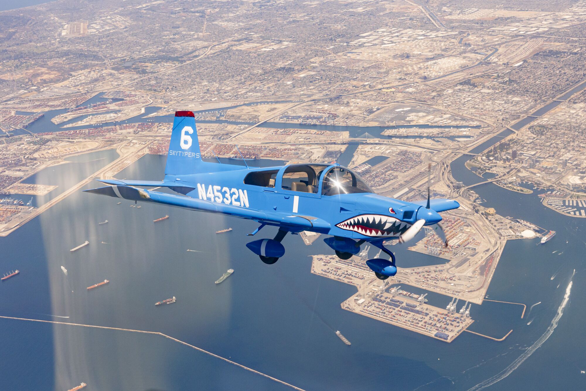 An airplane with the ocean and land beneath