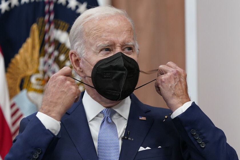 President Biden removes a face mask 
