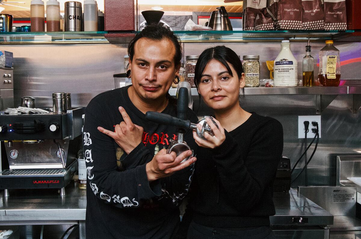 Julian Anguiano and Sol Castillo stand inside their new cafe.