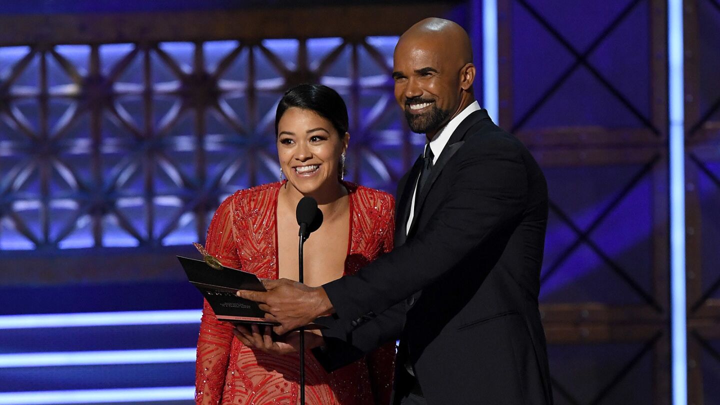 Actors Gina Rodriguez ("Jane the Virgin") and Shemar Moore ("Criminal Minds") speak onstage during the 69th Emmy Awards.