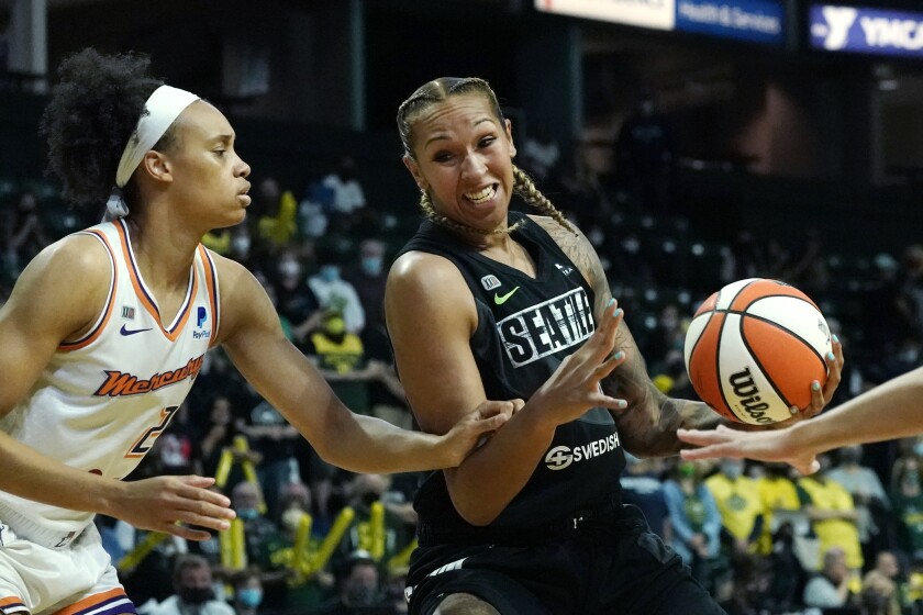 FILE - Seattle Storm's Mercedes Russell, right, drives against Phoenix Mercury's Megan Walker in the first half of the second round of the WNBA basketball playoffs, Sunday, Sept. 26, 2021, in Everett, Wash. Kelsey Mitchell, Lexie Brown and Mercedes Russell were the latest three WNBA players to sign up for the inaugural Athletes Unlimited Basketball season. (AP Photo/Elaine Thompson, File)