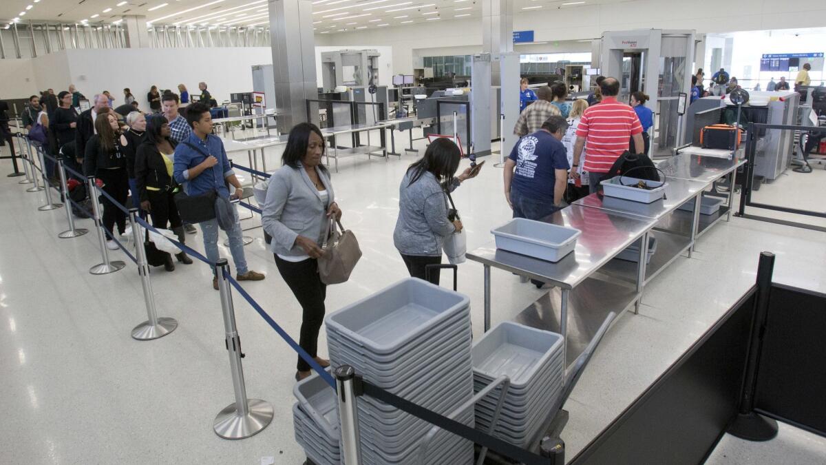 Passengers going through a security checkpoint at Florida airport.