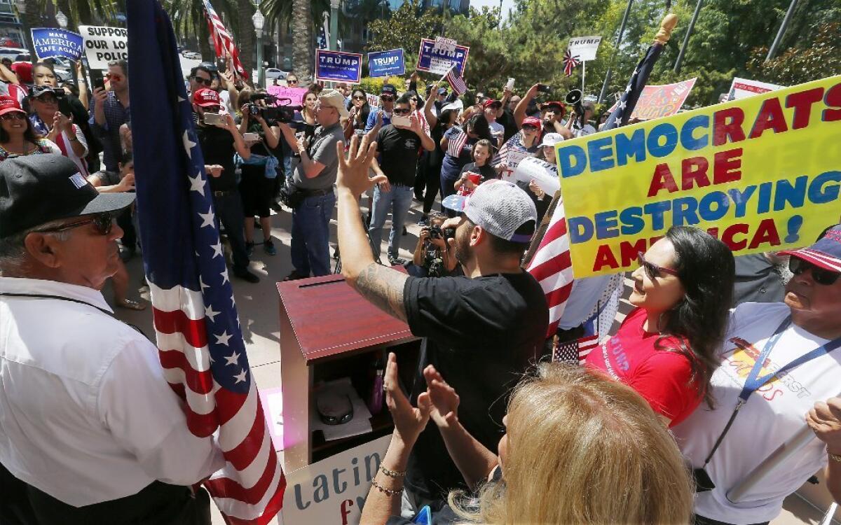 Jorge Herrera, a Los Angeles resident and a member of the political group Latinos for Trump, speaks to supporters of GOP presidential candidate Donald Trump outside Anaheim City Hall on Sunday.