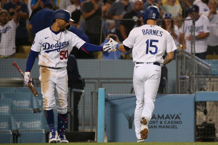 LOS ANGELES, CA - AUGUST 24: Austin Barnes gets congratulated by Mookie Betts following his two-run homerun in the sixth inning against the Milwaukee Brewers at Dodger Stadium on Wednesday, Aug. 24, 2022 in Los Angeles, CA. (Myung J. Chun / Los Angeles Times)