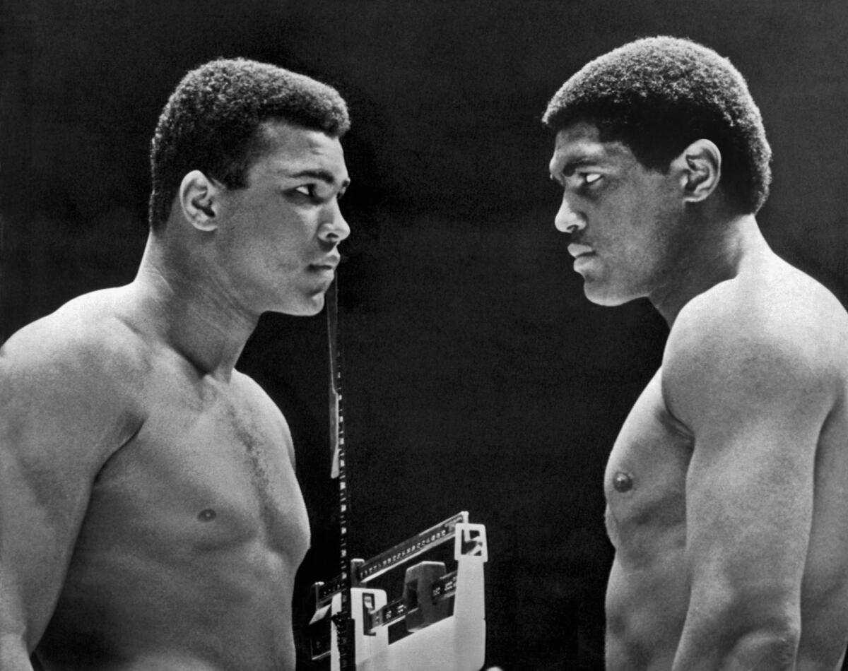 Heavyweight champion Muhammad Ali, left, faces off against challenger Ernie Terrell during the weigh-in for their 1967 title fight at the Houston Astrodome.