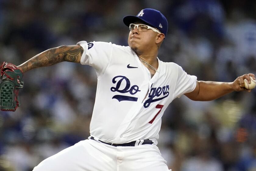 Los Angeles Dodgers starting pitcher Julio Urias throws to a San Diego Padres batter.