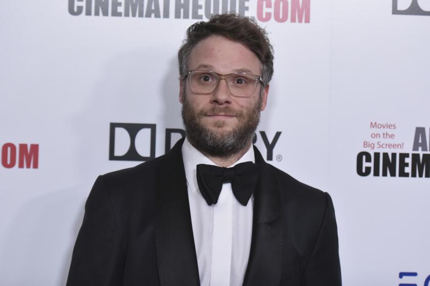 A bearded man wearing glasses and a black tuxedo