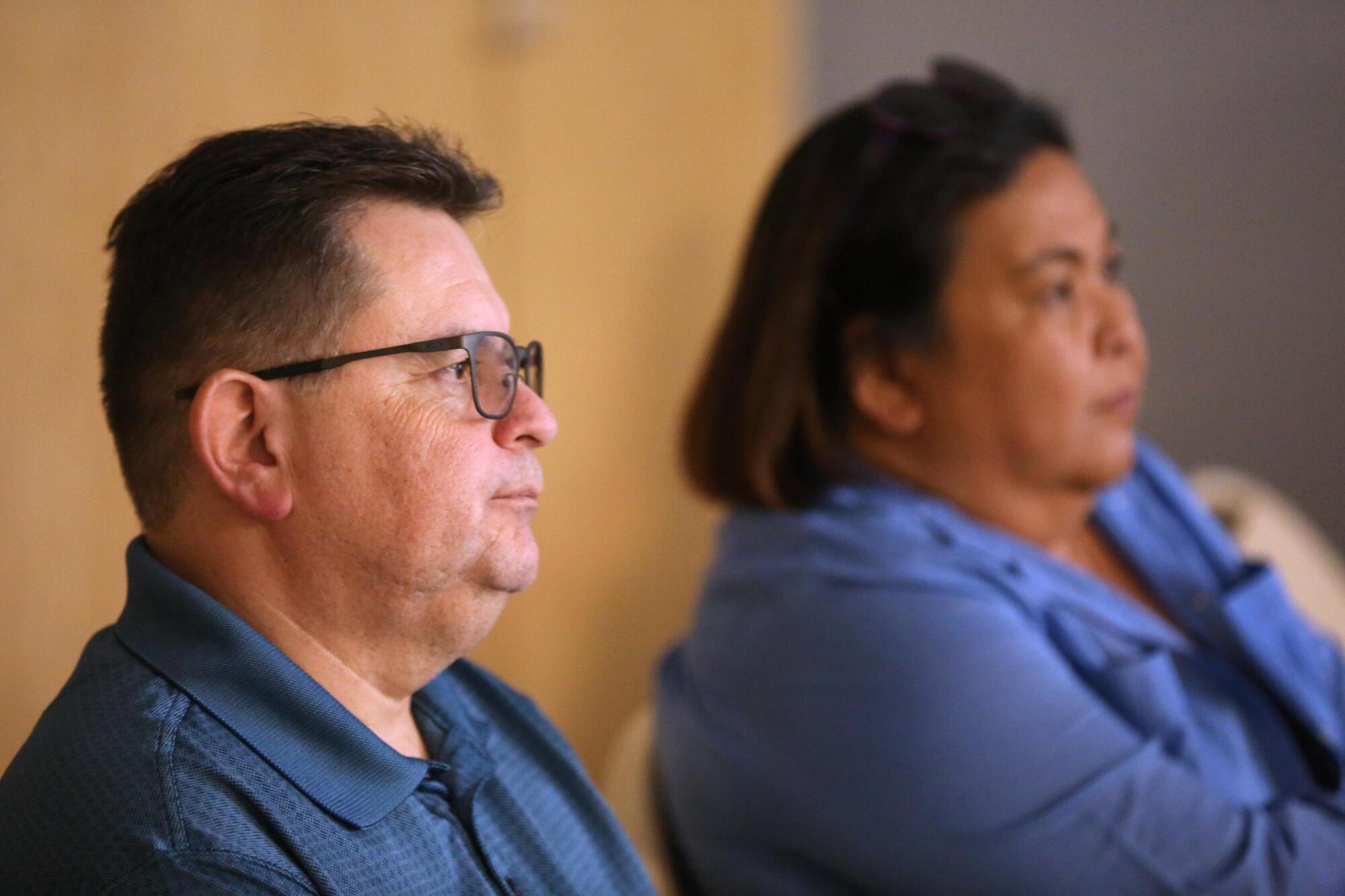 Raul Rodriguez sitting near another person, both facing right and pictured from the shoulders up