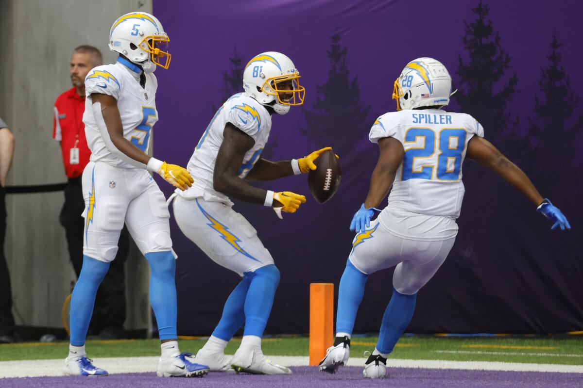 Chargers wide receiver Mike Williams (81) celebrates with teammates Joshua Palmer (5) and Isaiah Spiller.