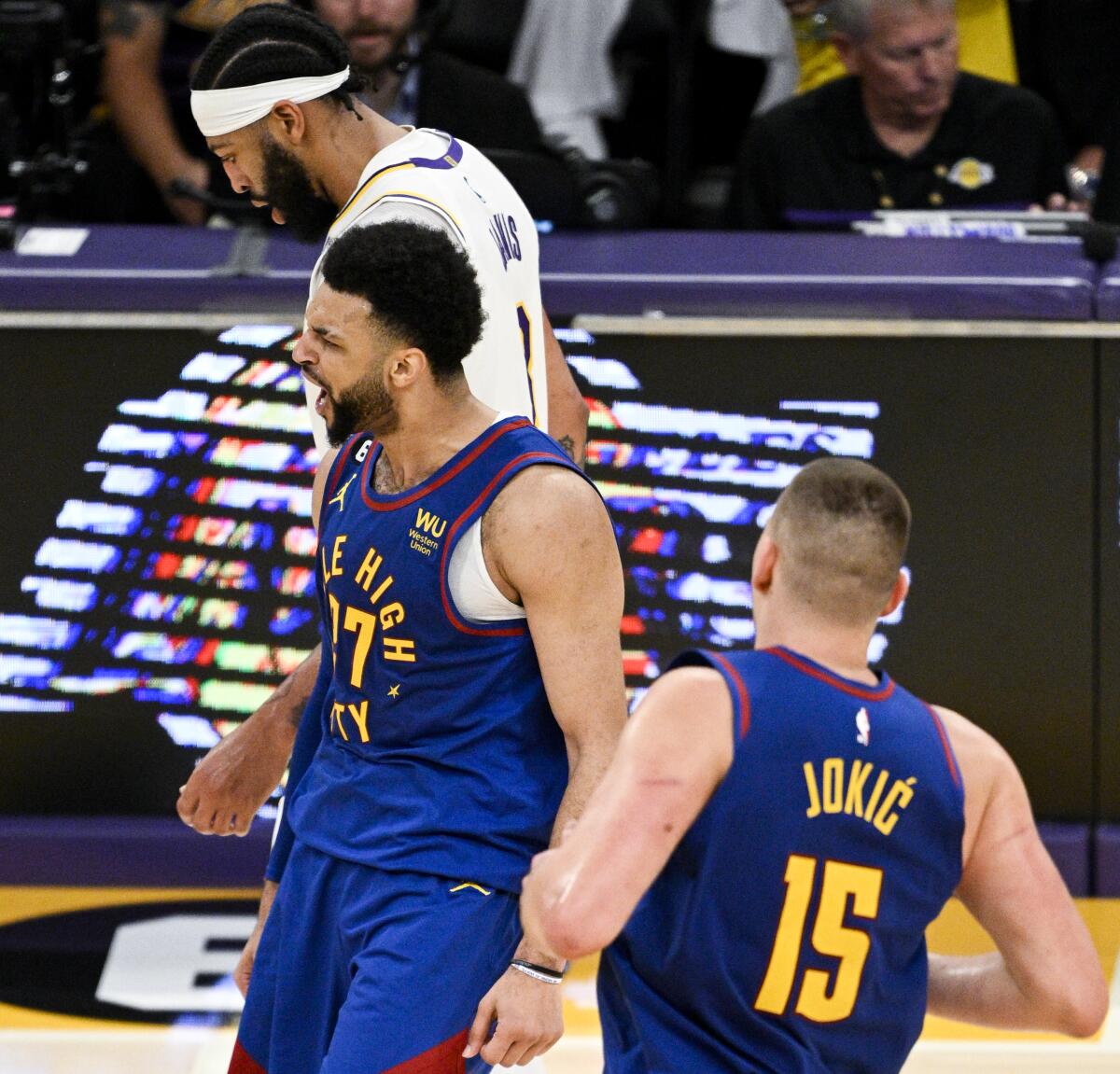 Nuggets guard Jamal Murray, center, celebrates a shot made in front of Lakers forward Anthony Davis.