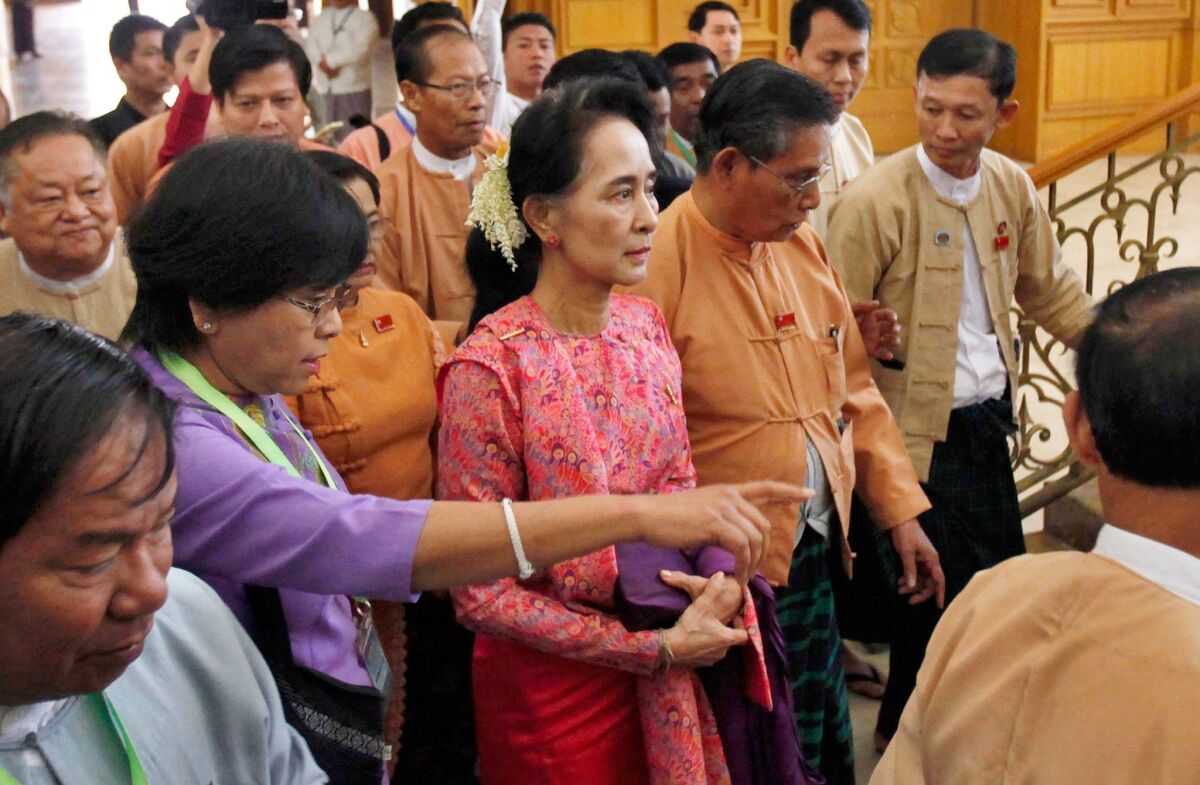 Myanmar’s pro-democracy leader Aung San Suu Kyi, center, arrives to participate in the inaugural session of Myanmar's lower house parliament in Naypyitaw, Myanmar on Feb. 1.
