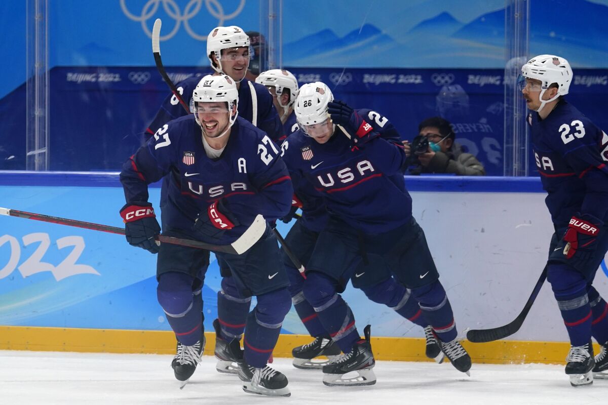 United States' Noah Cates (27) celebrates after scoring a goal against China during a preliminary round men's hockey game at the 2022 Winter Olympics, Thursday, Feb. 10, 2022, in Beijing. (AP Photo/Matt Slocum)