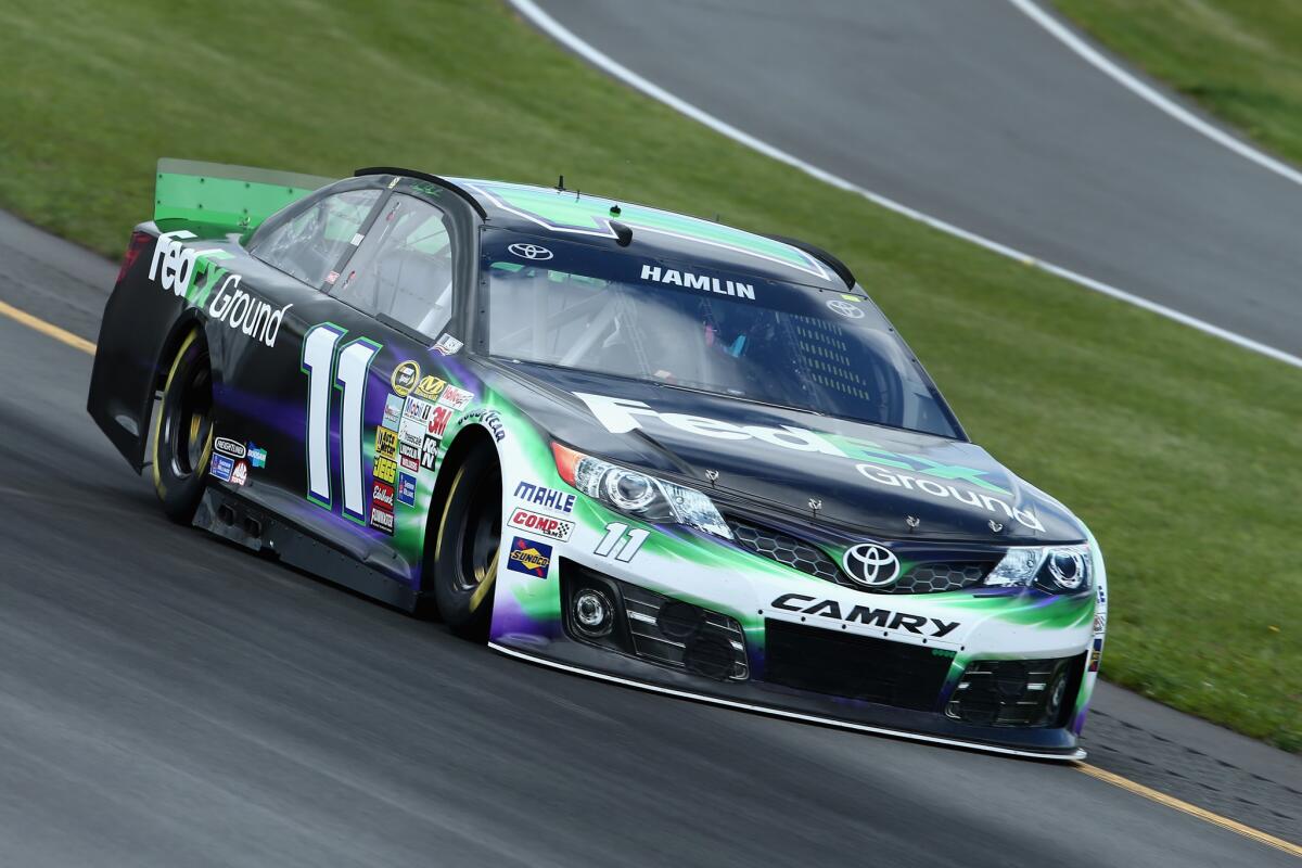 NASCAR driver Denny Hamlin takes his No. 11 Toyota for a practice run at Pocono Raceway on Friday before winning the pole position for Sunday's race.