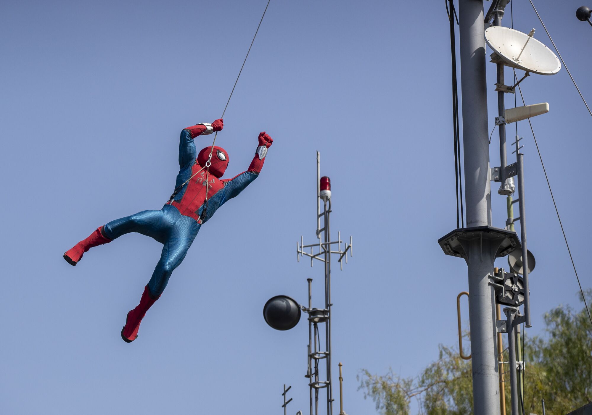 A robot Spider-Man soars through the air 