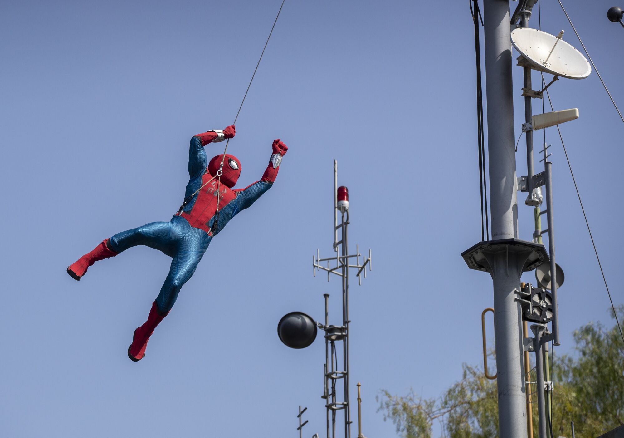 A robot Spider-Man soars through the air