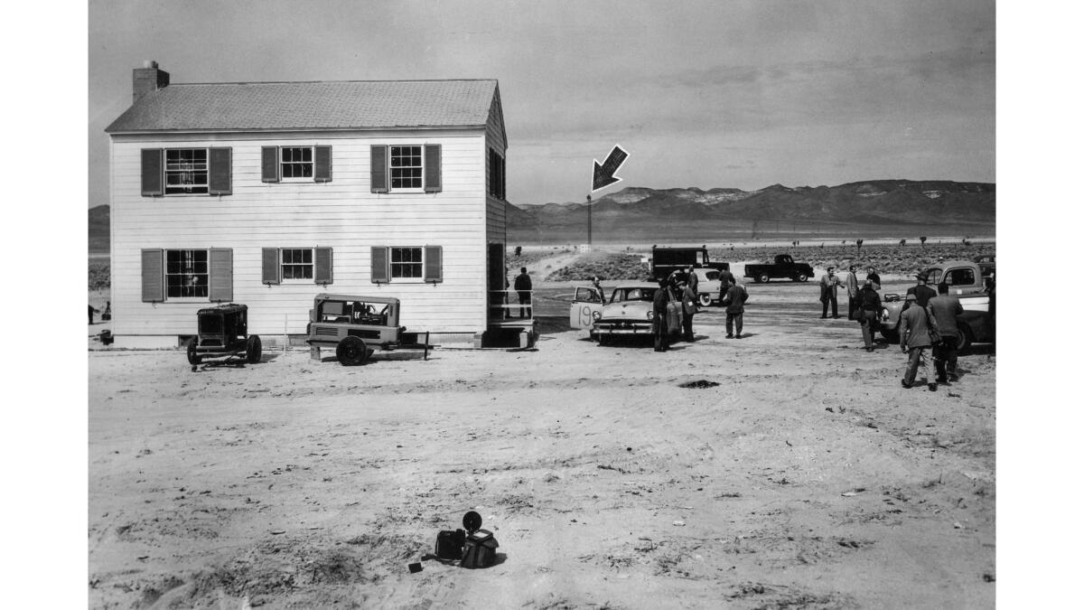 May 15, 1953: A typical American home sits a mile and a half from 300-foot tower (arrow) with atomic device at the Nevada proving grounds.