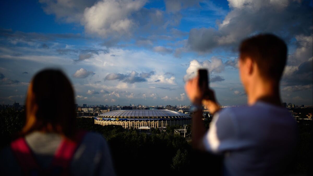 Visitors in Vorobyovy Hills, Russia, take in the view of the Luzhniki Stadium.