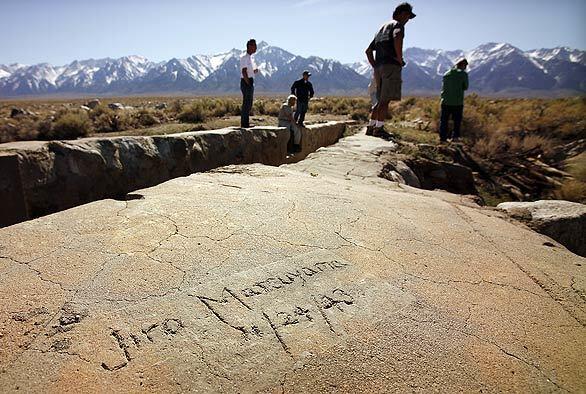 Japanese Americans recall fishing at Manzanar - name carved