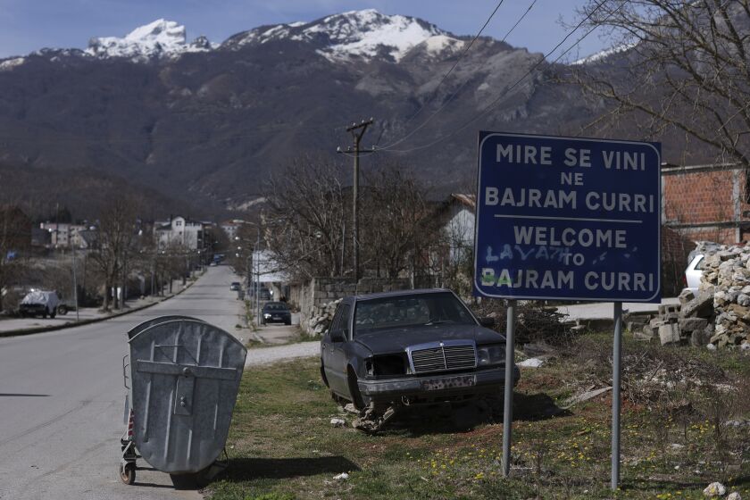 A welcome sign is seen at the entrance of Bajram Curri town, 240 kilometers (150 miles) northern of Tirana, Albania, Tuesday, March 14, 2023. Thousands of young Albanians have crossed the English Channel in recent years to seek a new life in the U.K. Their dangerous journey in small boats or inflatable dinghies reflects Albania's anemic economy and a younger generation’s longing for fresh opportunities. (AP Photo/Franc Zhurda)