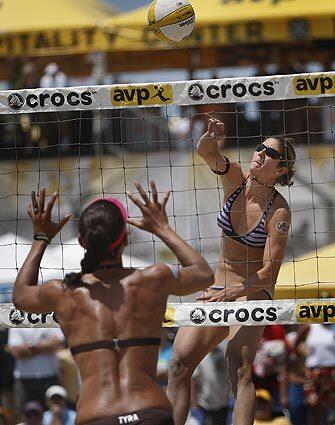 Nicole Branagh, right, spikes the ball against Tyra Turner during competition Sunday in the AVP Crocs Tour Gold Crown championships in Huntington Beach. Branagh and teammate Elaine Youngs won in the final when Kerri Walsh had to retire with a shoulder injury.
