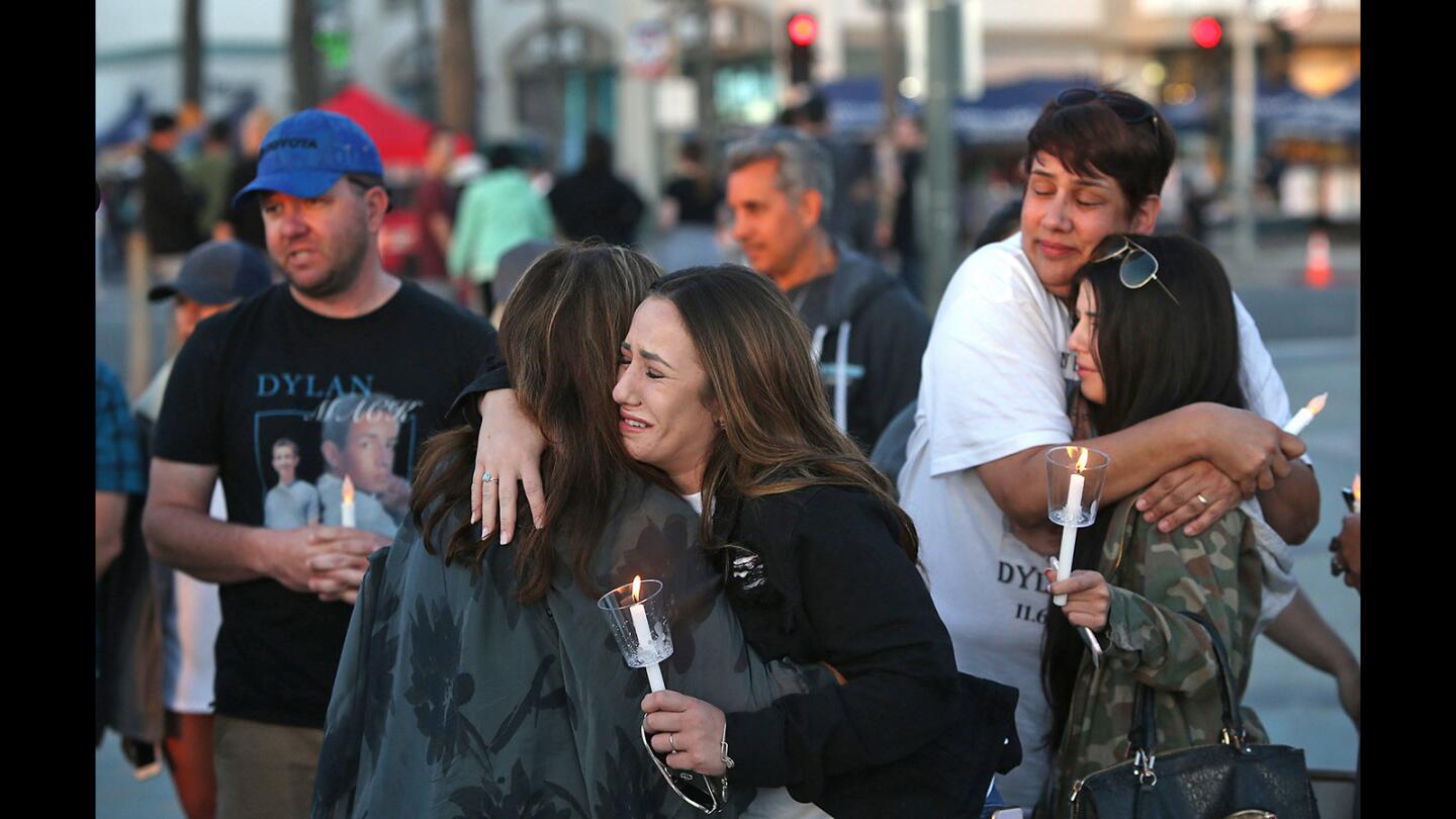 Allie Rossi, center, Renee Mack and Alicia Jimenez share hugs after hearing comments as they honor National Crime Victims' Rights Week during a ceremony Tuesday at Huntington Beach Pier Plaza. The three lost family members in a recent crash in Huntington Beach involving a possible drunk driver.