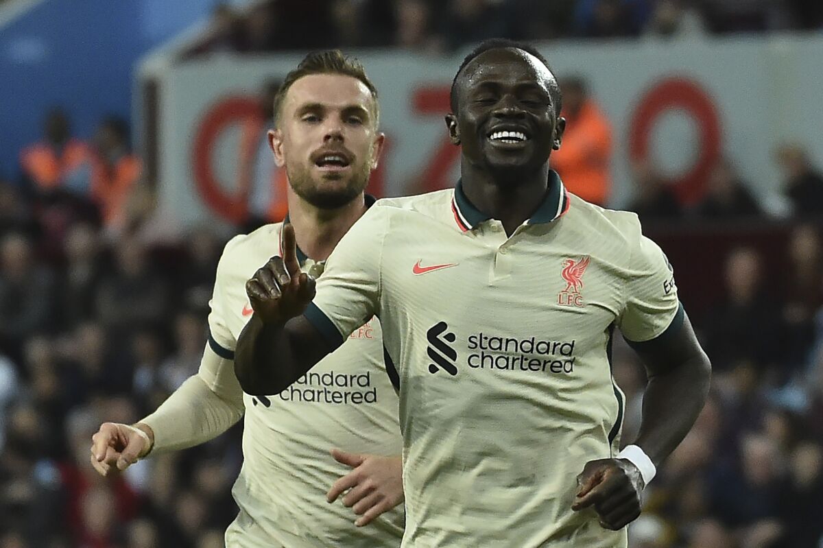 Liverpool's Sadio Mane, right, celebrates after scoring against Aston Villa during the English Premier League soccer match between Aston Villa and Liverpool at Villa Park in Birmingham, England, Tuesday, May 10, 2022. (AP Photo/Rui Vieira)
