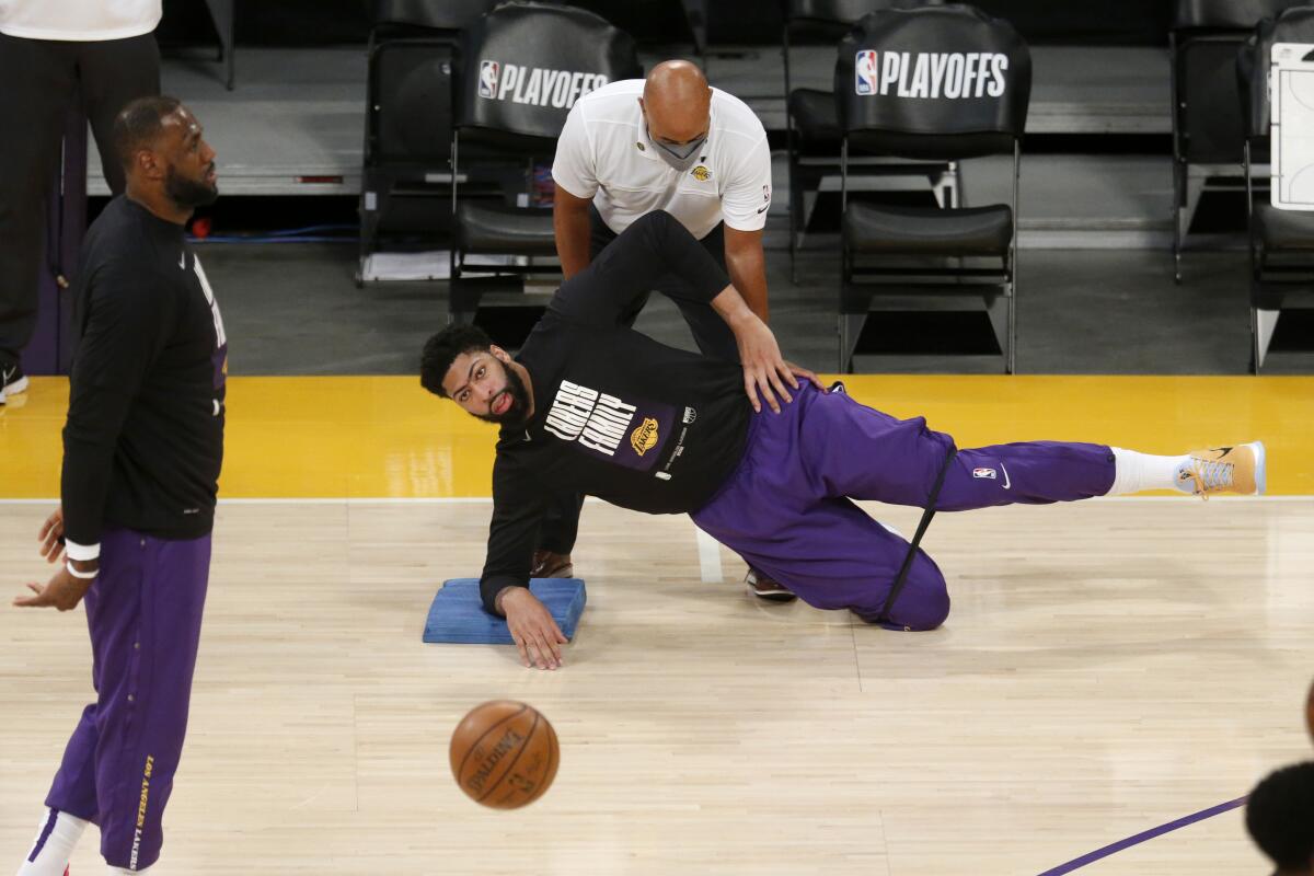 Lakers forward Anthony Davis stretches before the start of Game 4 against the Phoenix Suns.