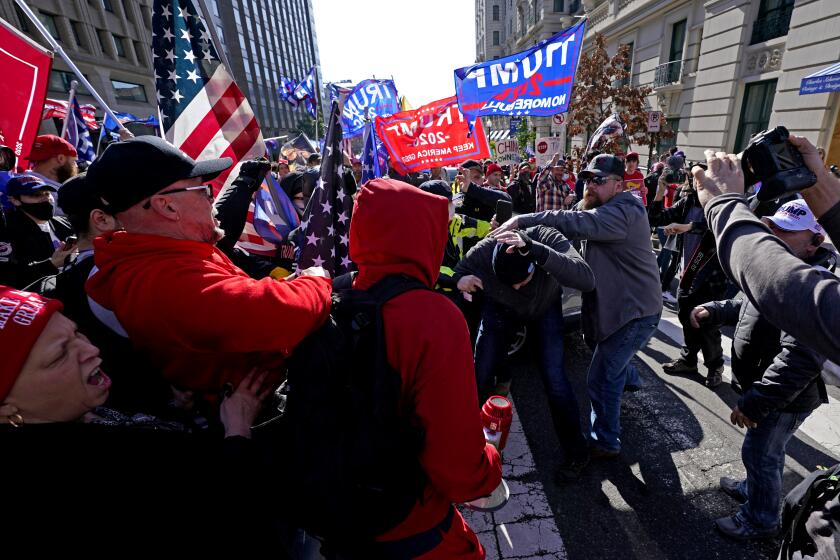 A fight breaks out as supporters of President Donald Trump and counter-protesters rally on Saturday, Nov. 14, 2020, in Washington. (AP Photo/Julio Cortez)