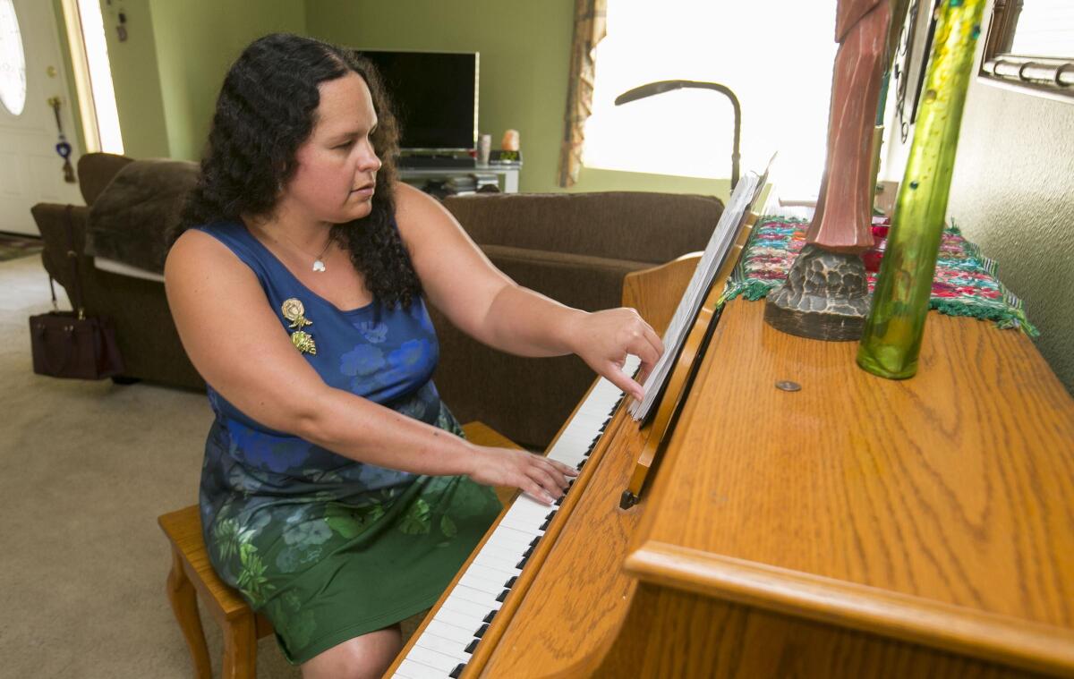 Katrina Aguilar, 32, a graduate of the Boston Conservatory, has written a stage show that in part tells the sometimes difficult story of her life's journey with autism using songs from Disney animated movies. She was photographed in her home in Rancho Peñasquitos on Thursday, Sept. 5.
