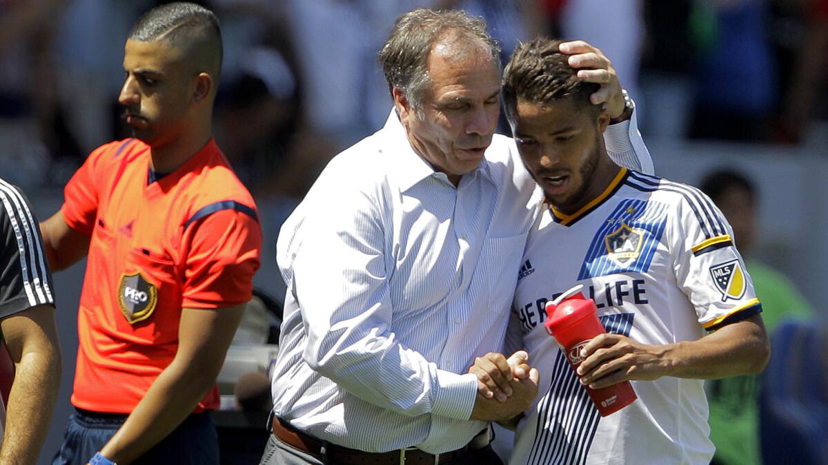 Galaxy coach Bruce Arena congratulates Giovani dos Santos as he's replaced in a 3-1 victory over the Sounders on Aug. 9.