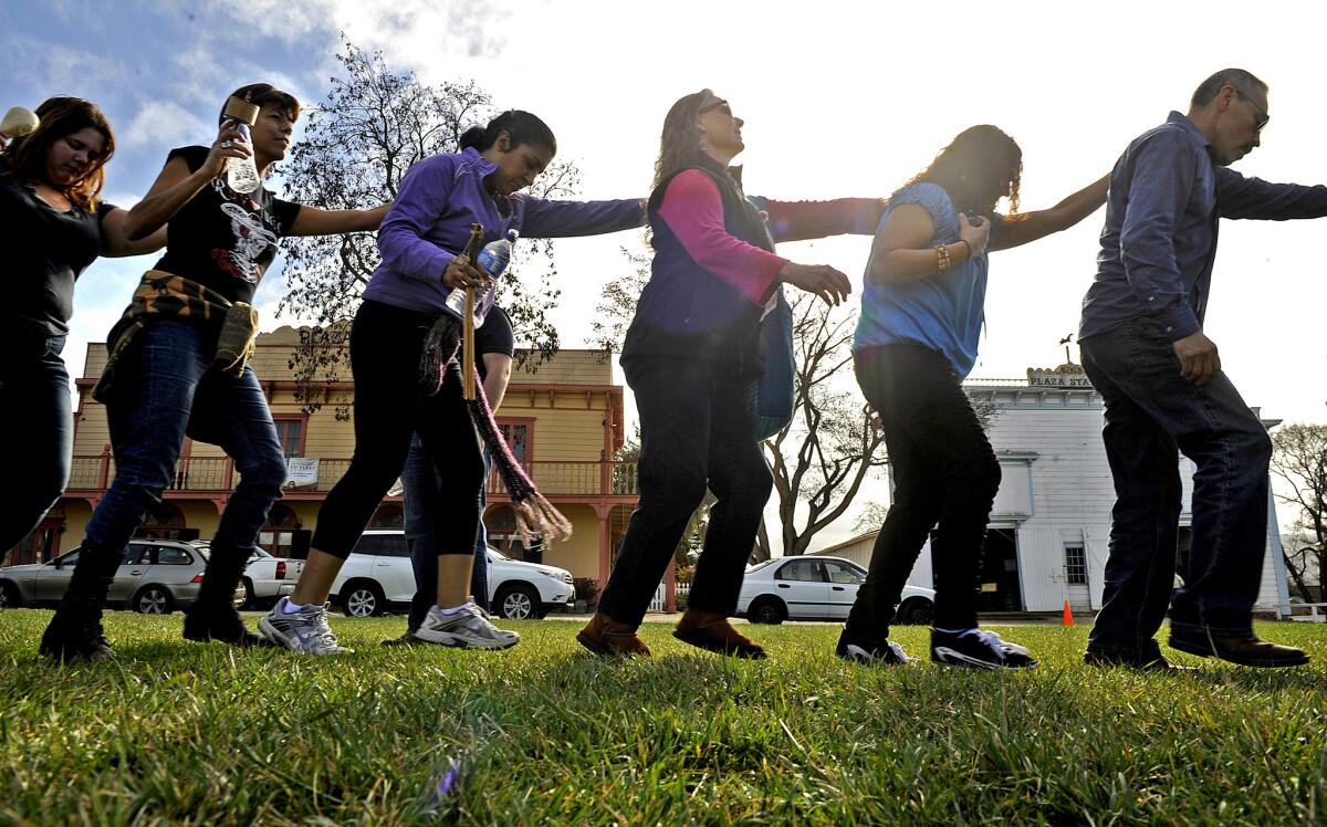 Participants dance in a circle during a rain dance in San Juan Bautista on a recent Sunday. In an attempt to end the drought, Buddhists hosted a dance in the Angeles National Forest.