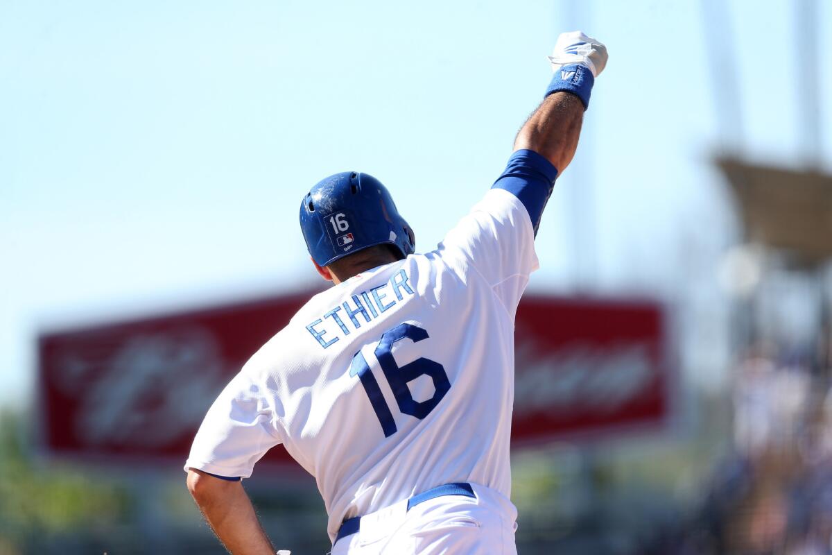 Dodgers outfielder Andre Ethier pumps his fist as he rounds first base after hitting a walk-off home run to beat the Angels.