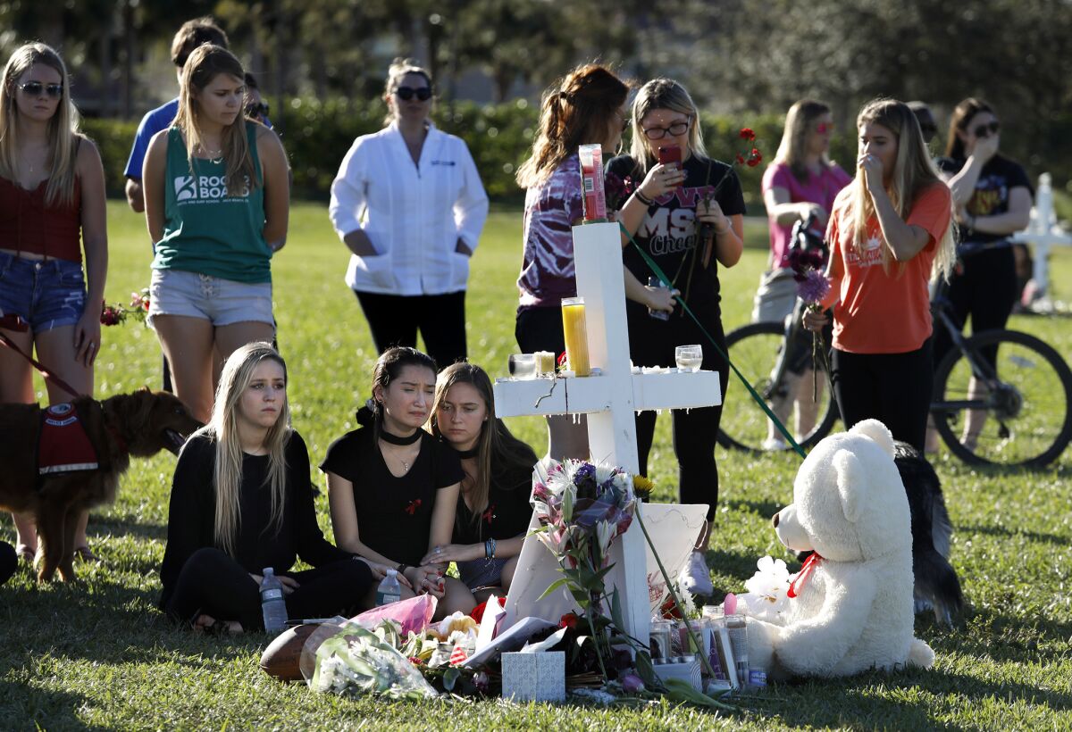 Students gather on Feb. 16, 2018, at a memorial in Parkland, Fla., to remember those killed and injured in the high school shooting.