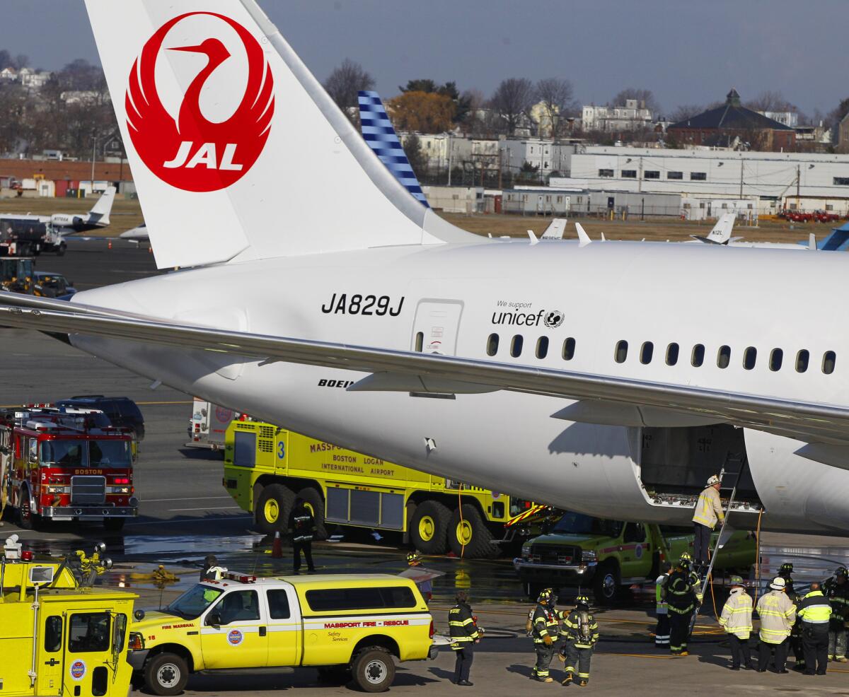 A Japan Airlines Boeing 787 jet is surrounded by emergency vehicles while parked at Boston's Logan International Airport after its batteries overheated in January 2013.