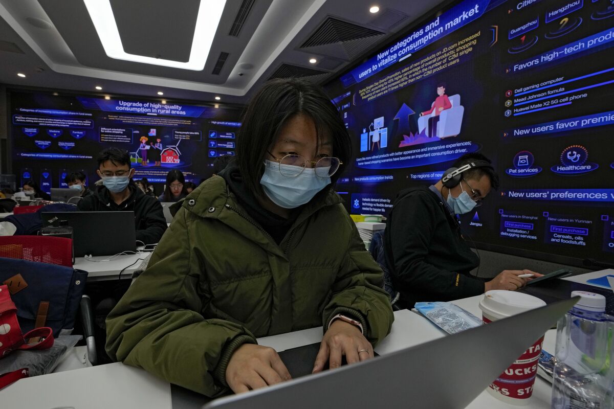 Workers work on computers as they setup for the up coming China's biggest online shopping day, known as "Singles' Day" in a command center at the headquarters of online retailer JD.com in Beijing on Tuesday, Nov. 9, 2021. China's biggest online shopping day, known as "Singles' Day" on Nov. 11, is taking on a muted tone this year amid a regulatory crackdown on the technology industry and President Xi Jinping's push for "common prosperity." (AP Photo/Andy Wong)