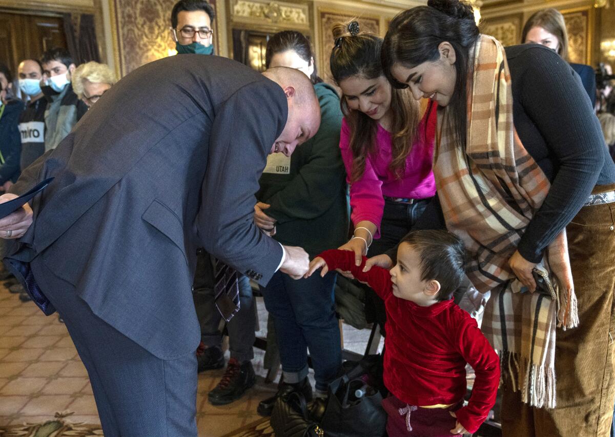 Utah's governor fist-bumps an Afghan toddler at the Capitol