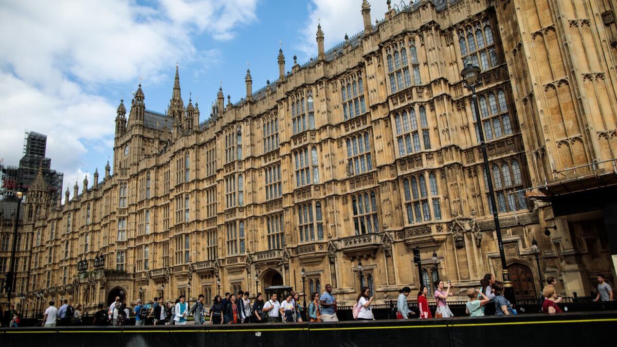 People walk past security barriers outside the Houses of Parliament in London following the attack this week. Salih Khater was named by police as the man who crashed his car outside the Houses of Parliament, injuring cyclists and pedestrians.