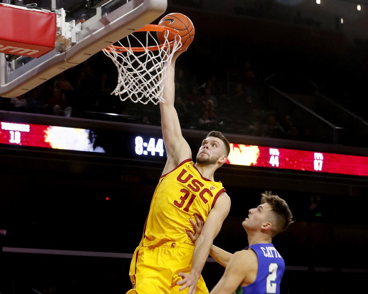 USC forward Nick Rakocevic dunks over Florida Gulf Coast guard Caleb Catto during the second half.